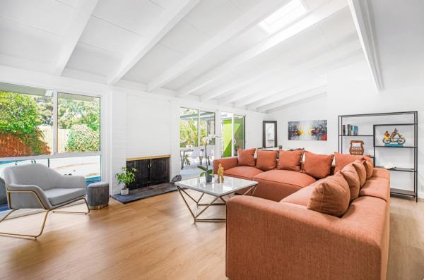 The home has beamed ceilings and floods with light.