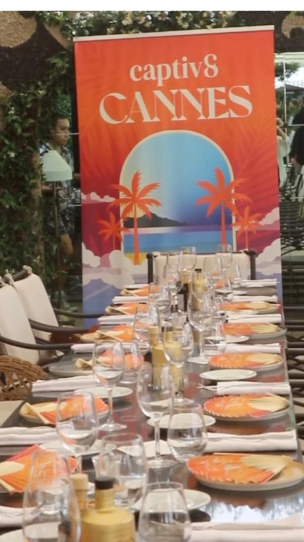 A long table setting with a Cannes sign at the head.