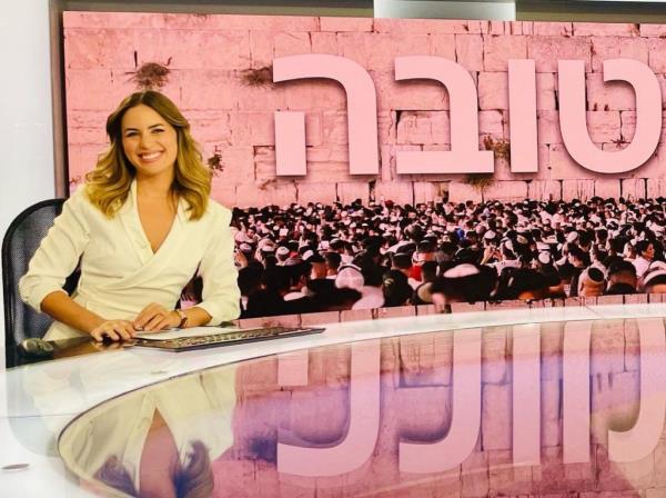 Dadon is seen above anchoring a news program from the N12 News studios in Israel.